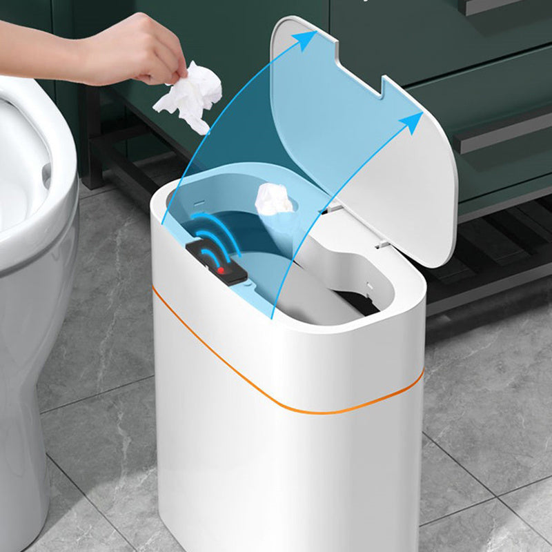 White trash bin with blue lid being used in a bathroom setting