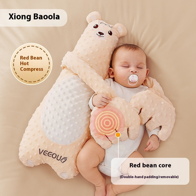 Baby sleeping with a bear-shaped pillow featuring a red bean hot compress.