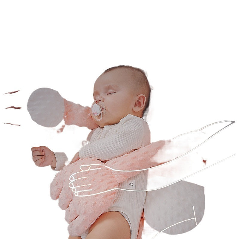 Baby being held with a pacifier and toy, on a white background