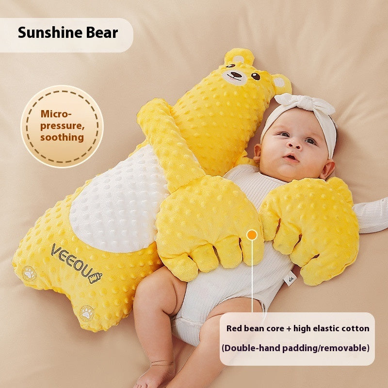 Baby lying on a yellow Sunshine Bear pillow with text describing its features.