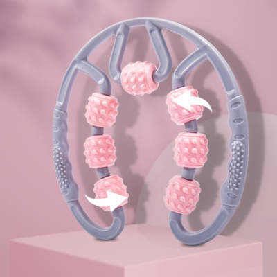 Pink and gray massage tool on a pink background