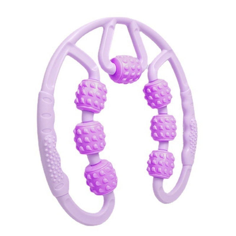 Purple massage tool with beads on a white background