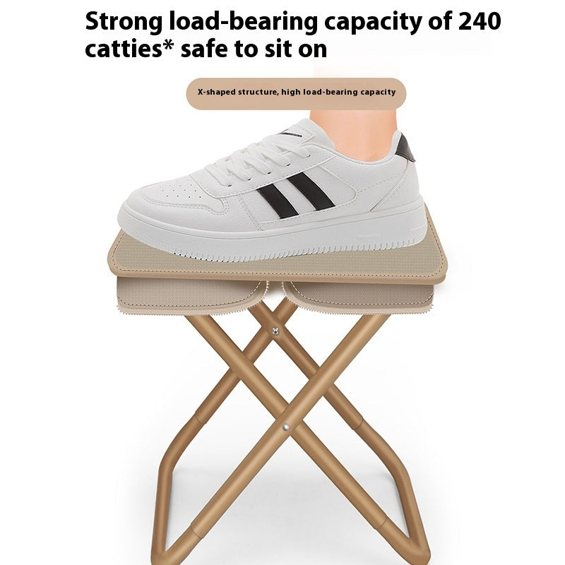 Small folding stool with a white shoe on top, indicating its load-bearing capacity.