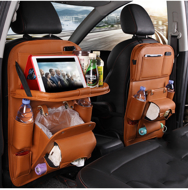 Car back seat organizer with multiple pockets and a tablet stand, filled with items.