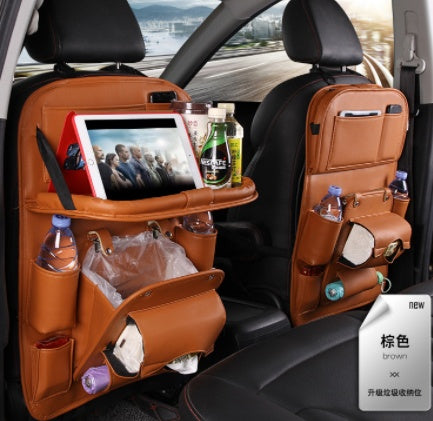 Car backseat organizer with multiple pockets and a tablet stand, filled with items, on a car seat.