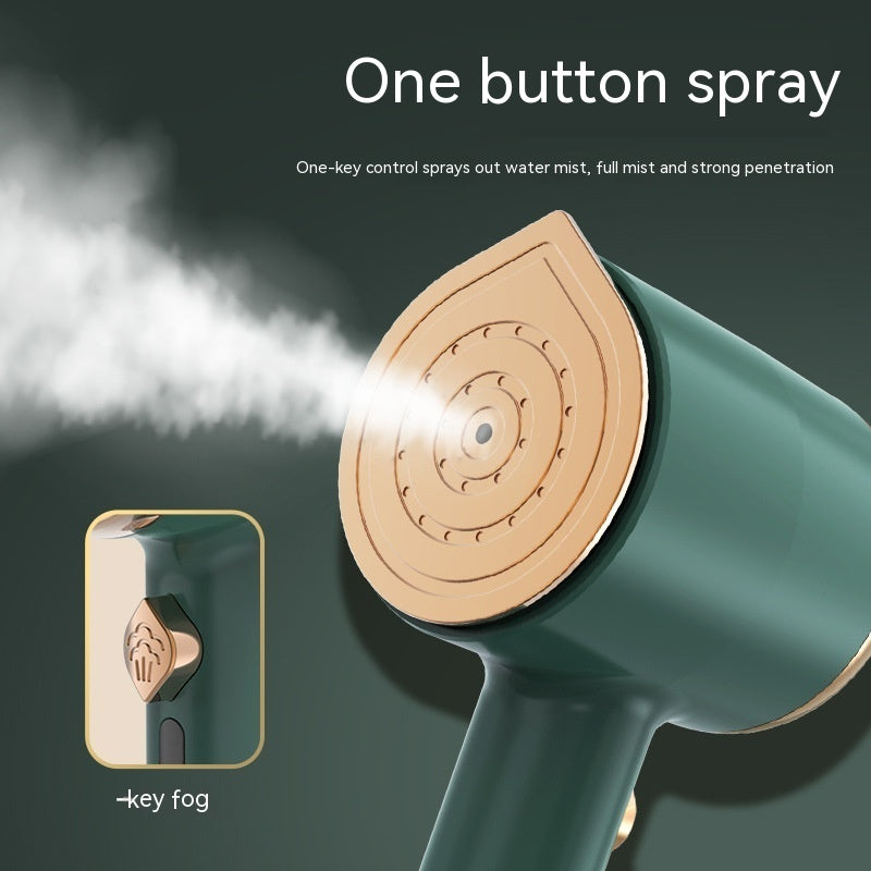 Green handheld device with gold nozzle spraying water mist on a dark background