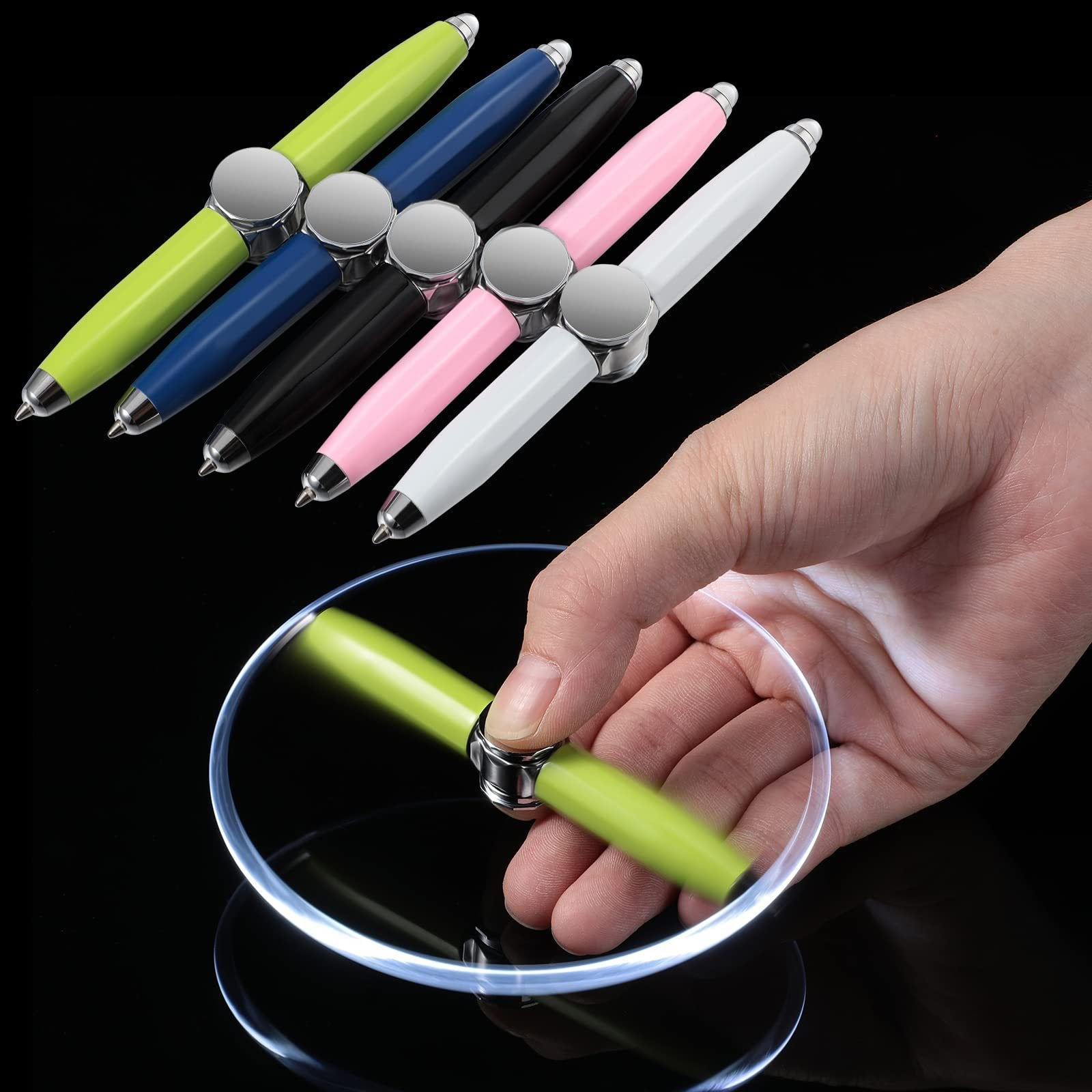 Set of colorful pens with a hand holding a green pen on a black background