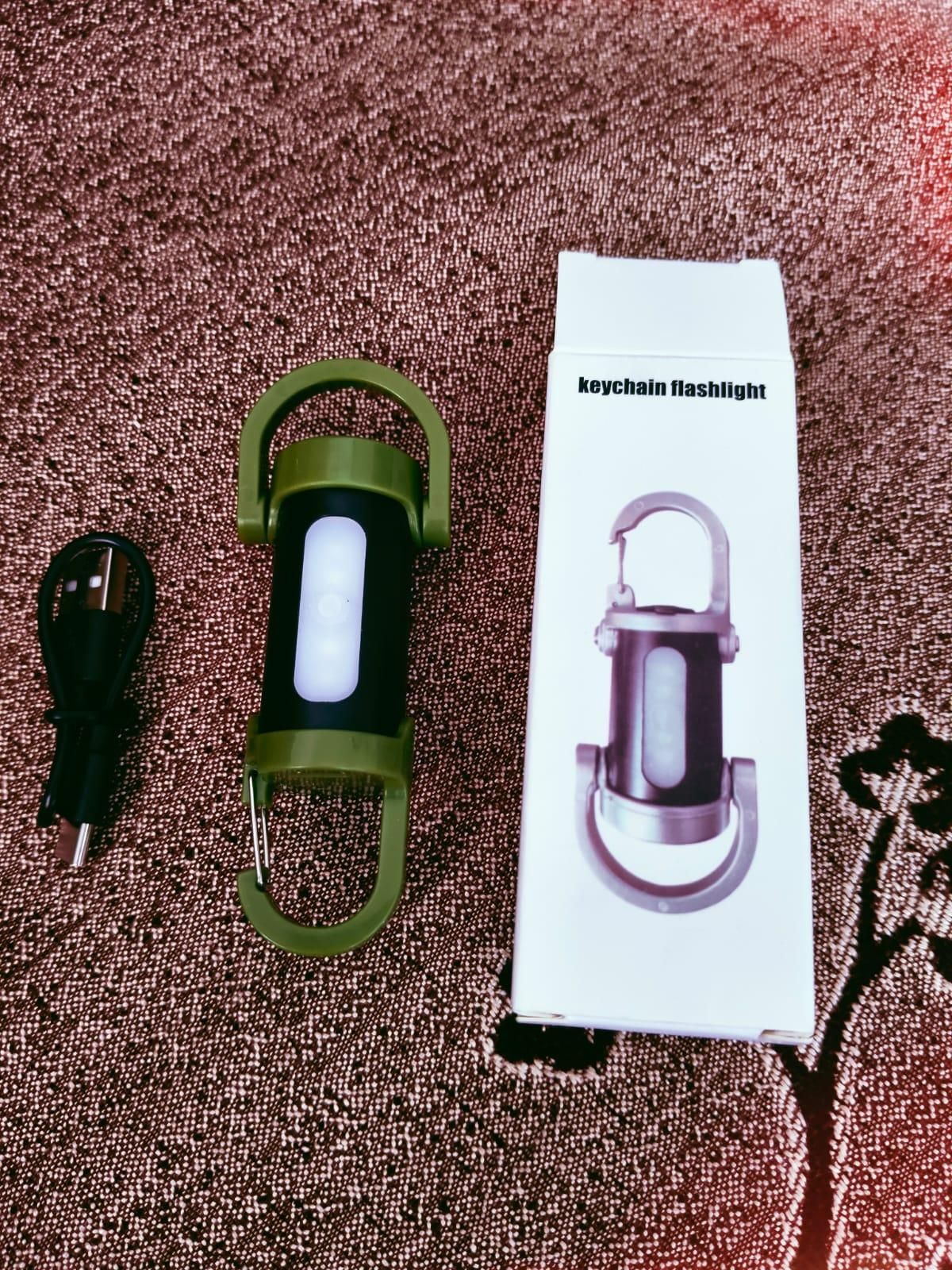 Keychain flashlight with packaging on a textured surface