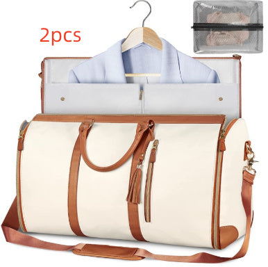 White duffel bag with brown leather accents and a clear travel organizer on a white background