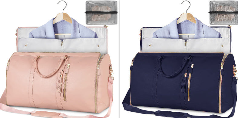 Pink and navy travel bags with hangers and clothes on a white background