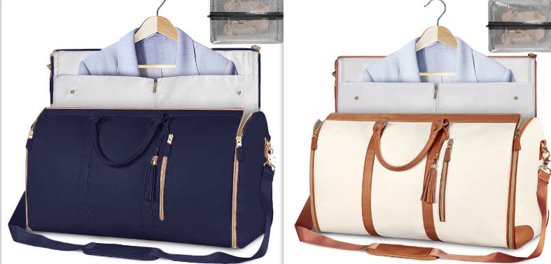 Two travel bags, one navy and one cream with brown straps, on hangers.