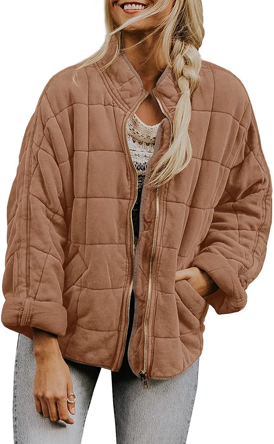 Woman wearing a brown quilted jacket on a white background