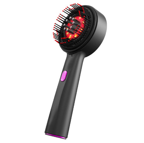 A person is holding a red electric massage comb with a black head, demonstrating its design and size.