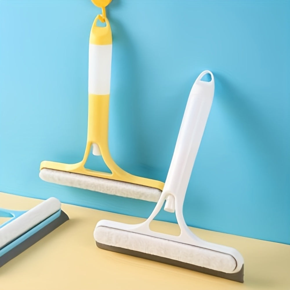 Two squeegees on a yellow surface with a blue background