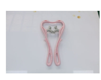 Pink and gray object resembling a tooth on a white background