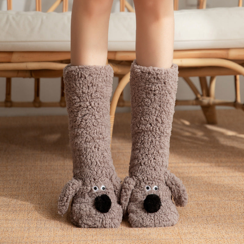 Brown dog-shaped slippers worn by a person on a carpeted floor.