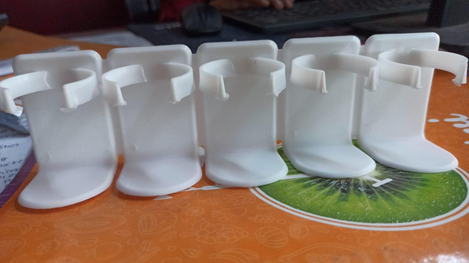 White boot-shaped objects on a colorful surface with a keyboard in the background