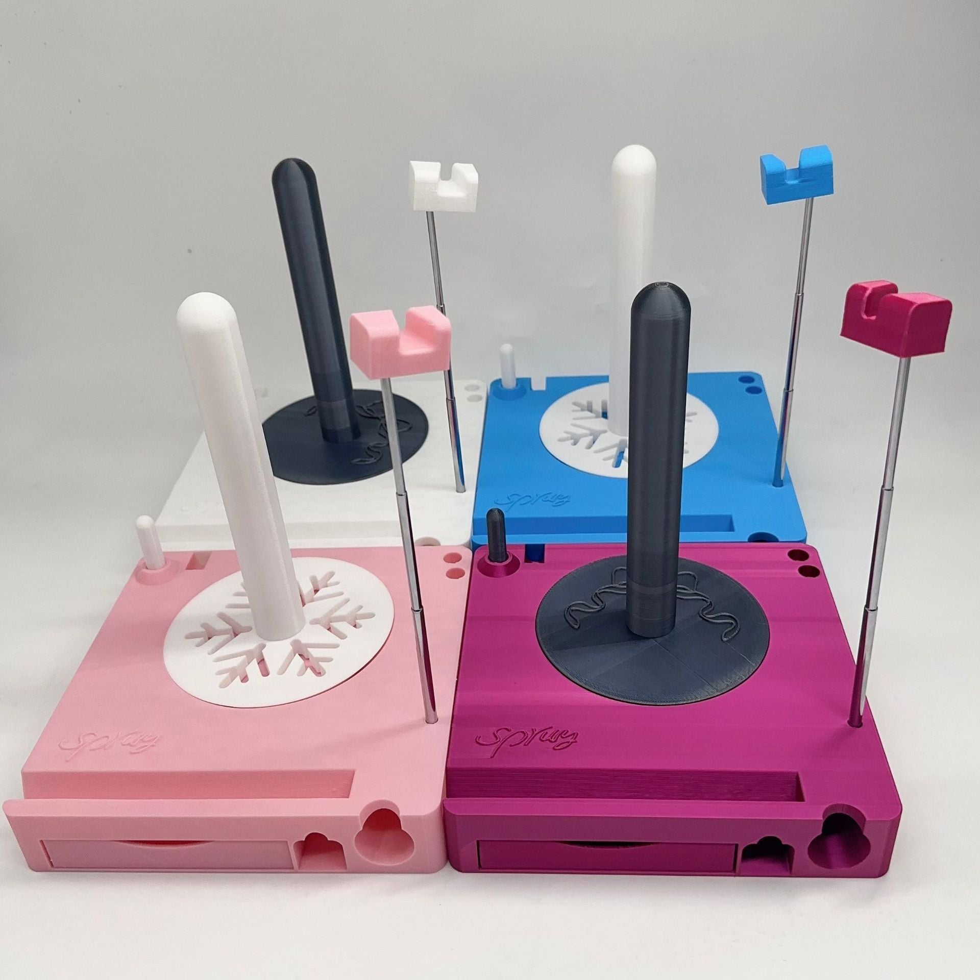 Pink and blue plastic mold set with various components on a white background