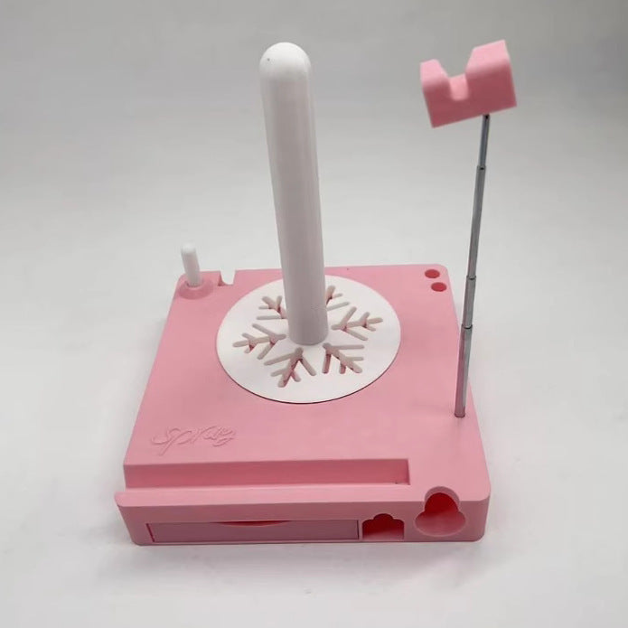 Pink snowflake-themed cookie cutter on a white background