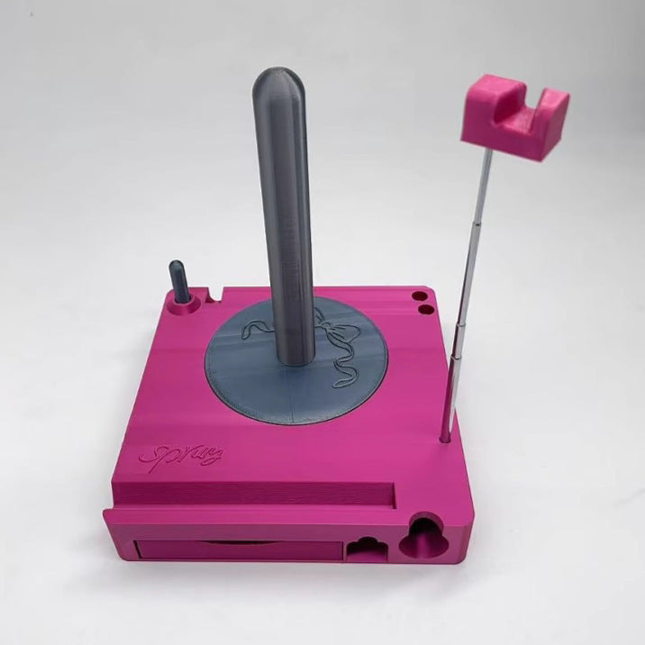 Pink mechanical device with a central rod and side components on a white background
