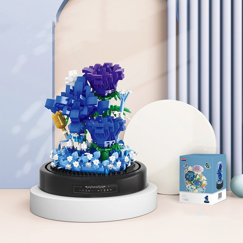 Blue and purple floral LEGO model on a stand with packaging in the background