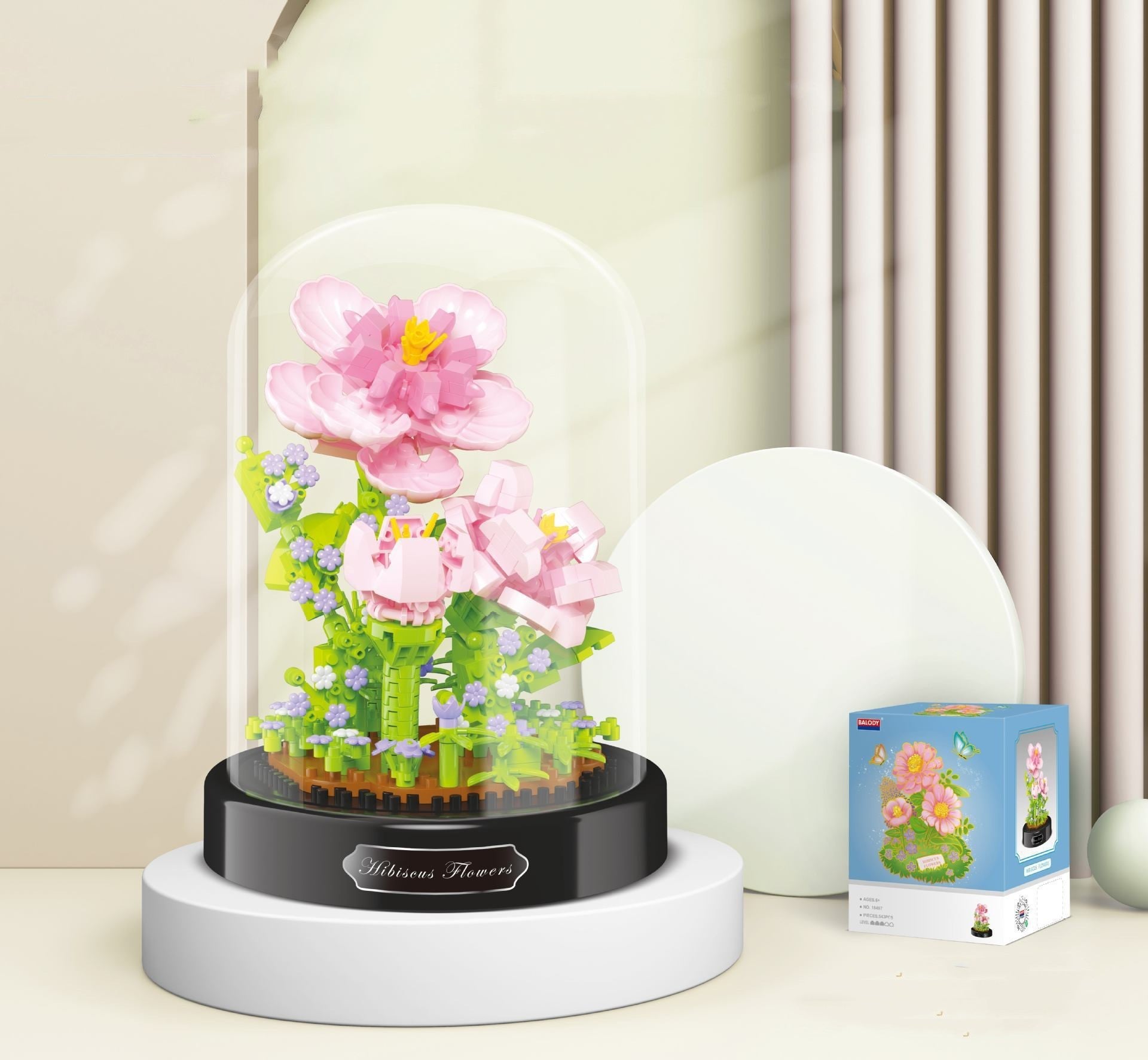 Decorative flower arrangement in a glass dome on a white surface with a neutral background