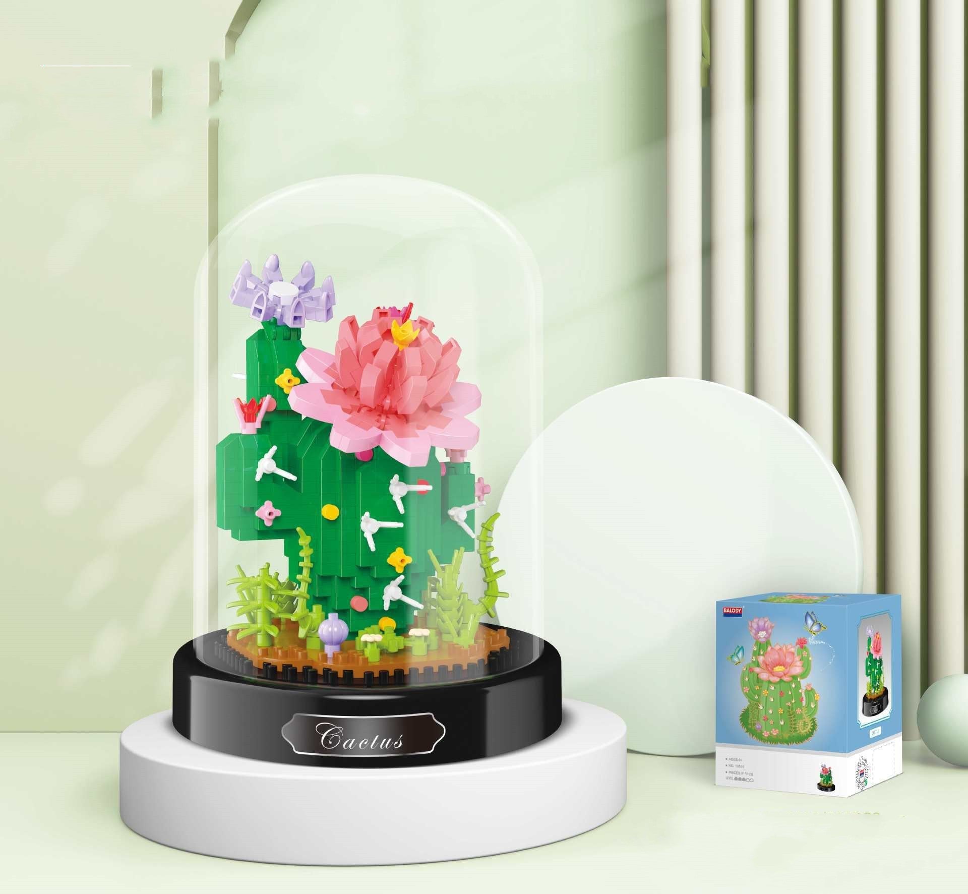 Cactus-shaped building block set in a glass dome on a light green background
