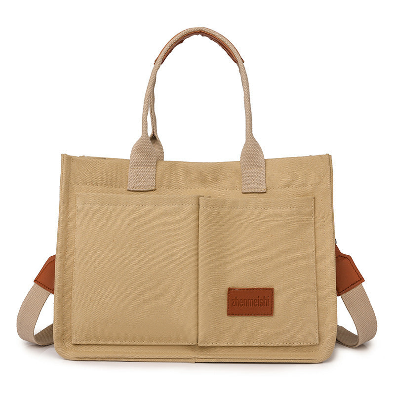 A collection of canvas tote shoulder bags in various colors, displayed in multiple pockets and with adjustable shoulder straps, showcased in a vertical format.