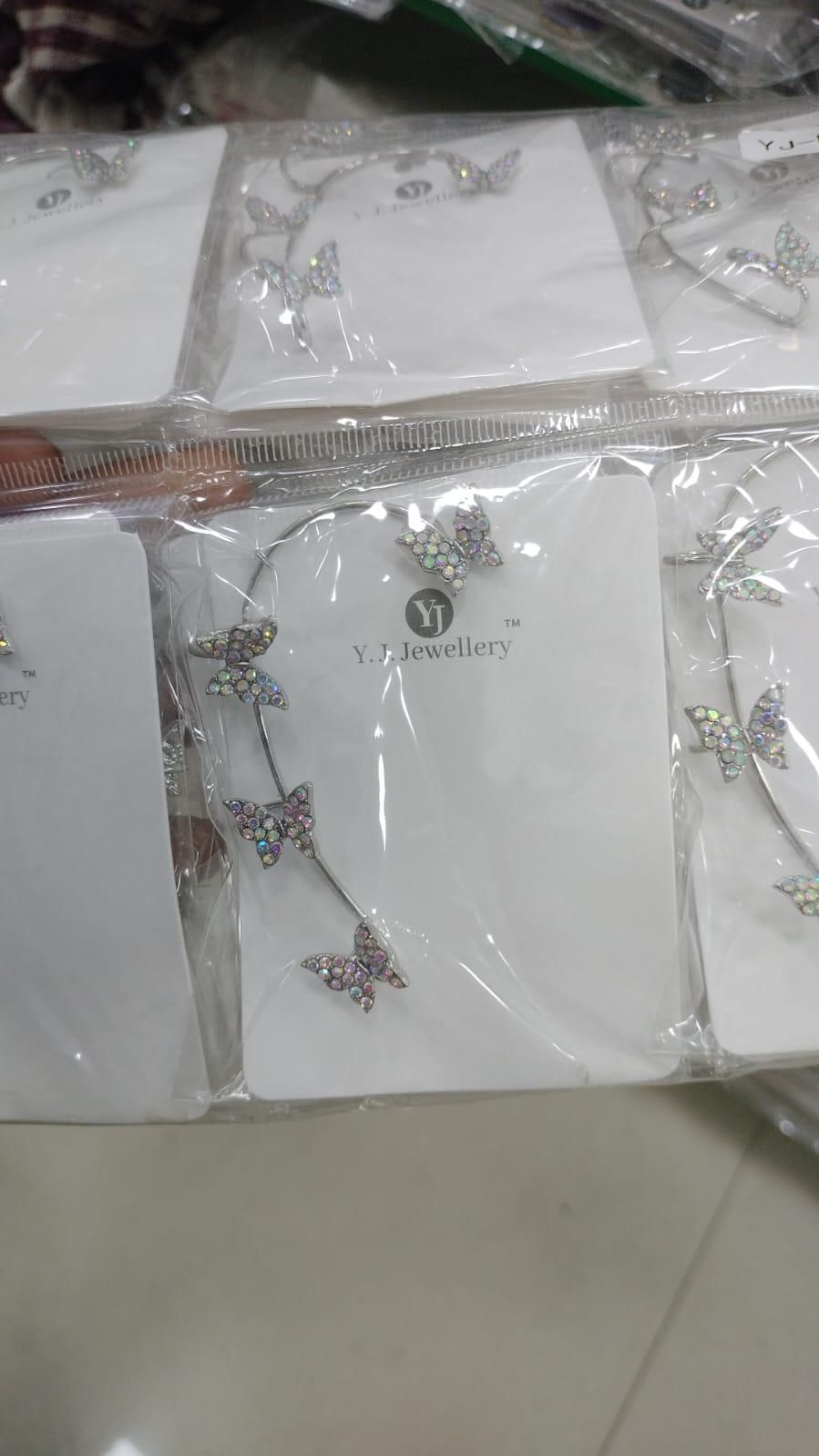 Butterfly-shaped earrings on a card with 'Vivienne' branding.