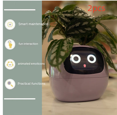 Smart robot with animated emoticons next to a plant on a table