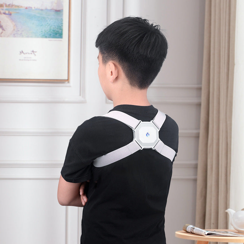Person wearing a white back brace in a room with a light-colored wall and framed picture.