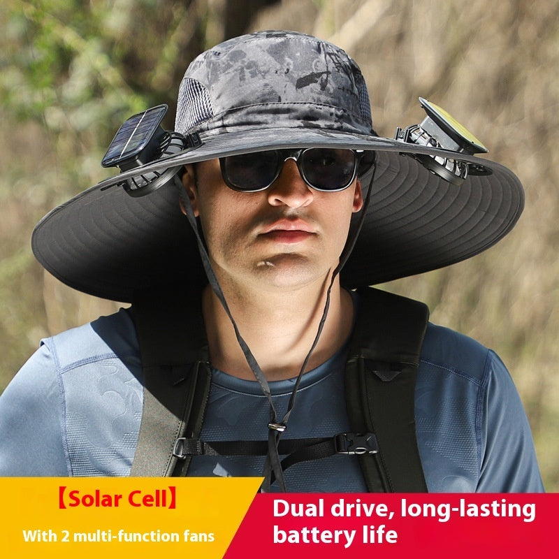 Person wearing a large sun hat with solar cell and fans, outdoor setting