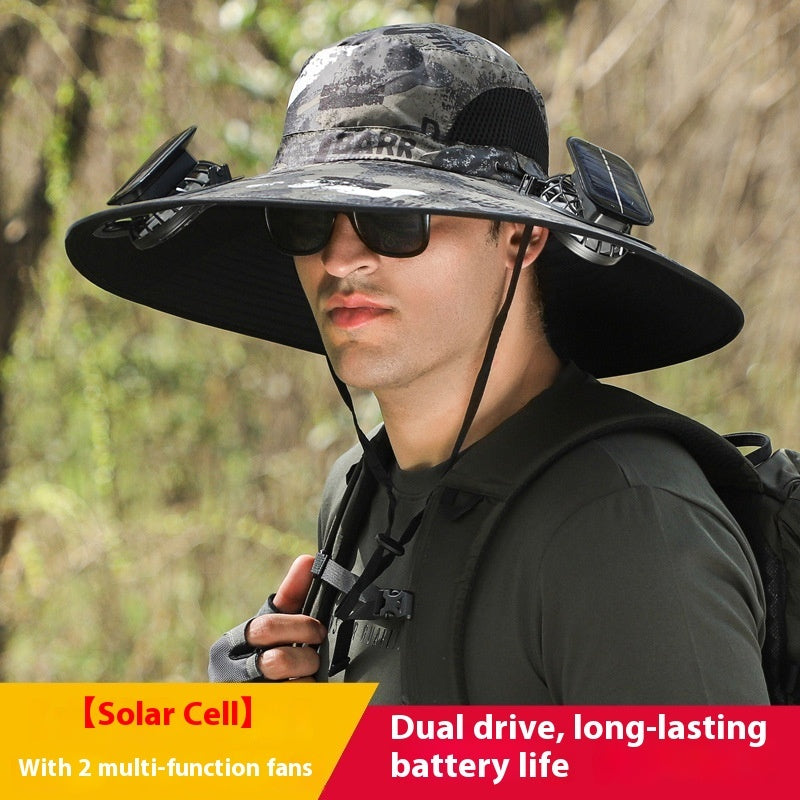 Person wearing a large sun hat with solar cells and fans, standing in a forest setting.