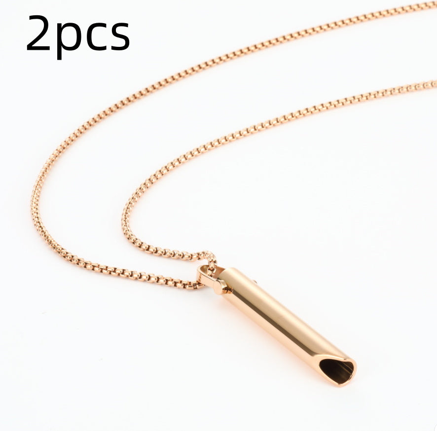 Rose gold necklace with cylindrical pendant on a white background