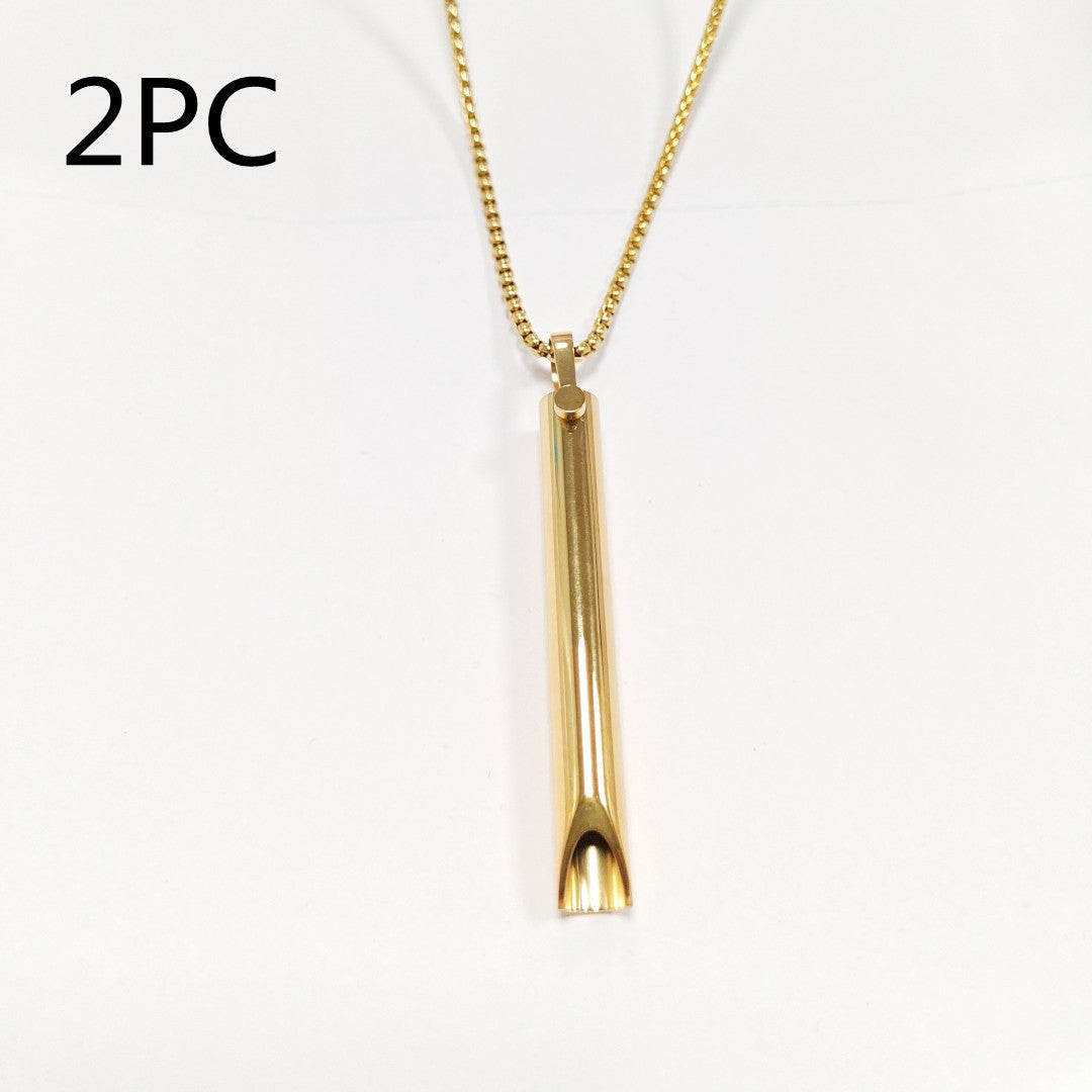 Gold necklace with a cylindrical pendant on a white background