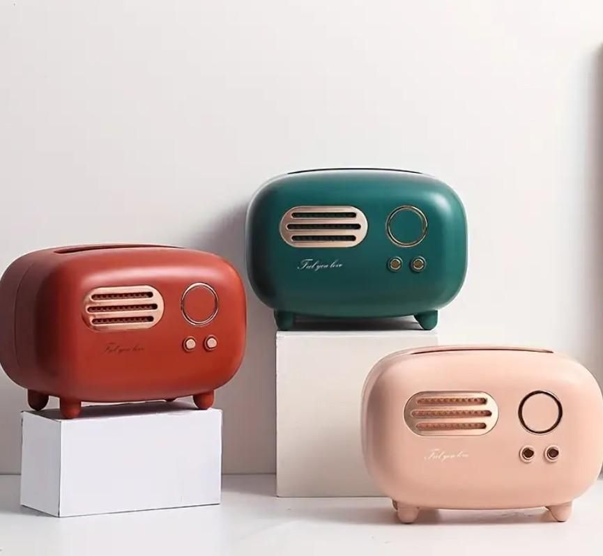 Three colorful vintage-style speakers on white stands against a light background
