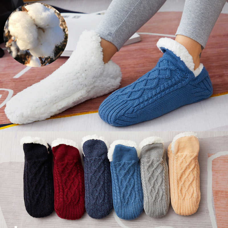 Knitted slippers with various color options displayed on a flat surface.