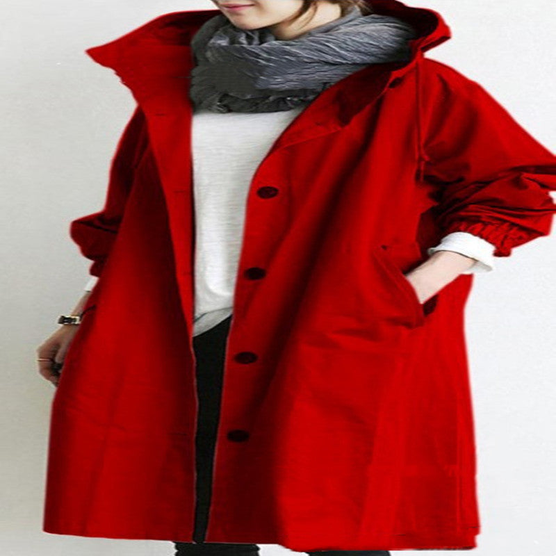 Person wearing a red coat with a plain background