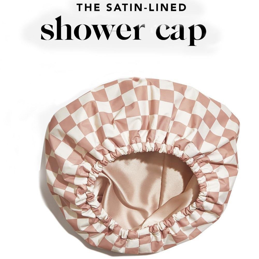 Checkered satin-lined shower cap on a white background