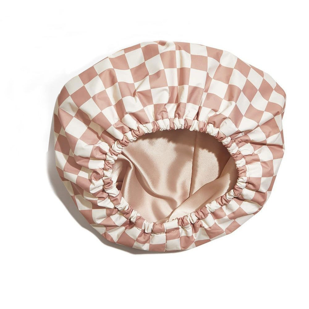Pink and white checkered satin bonnet on a white background