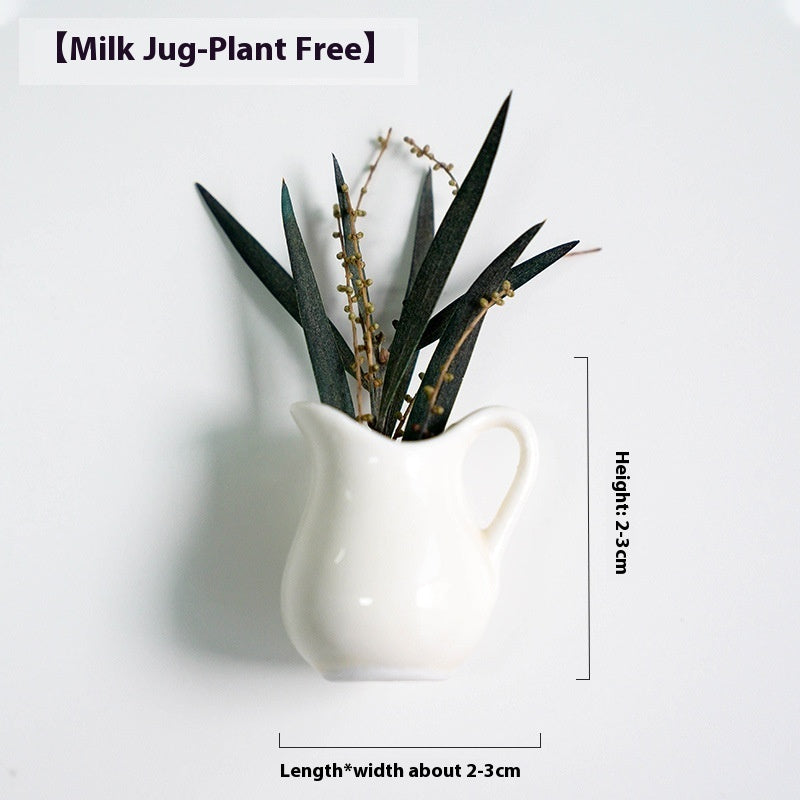 White milk jug with plants on a white background, showing dimensions.