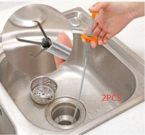Plumbing tool being used to clear a sink drain with '2PCS' text visible.