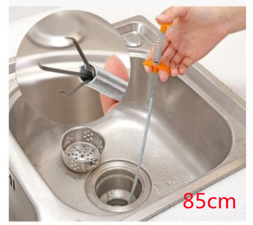 Person using a metal drain snake to clear a clogged sink drain.