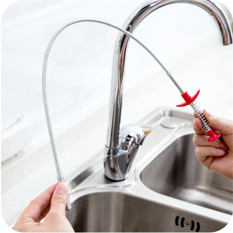 Person using a flexible water faucet attachment in a kitchen sink.