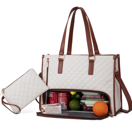 White quilted diaper bag with brown straps containing snacks and fruits on a white background